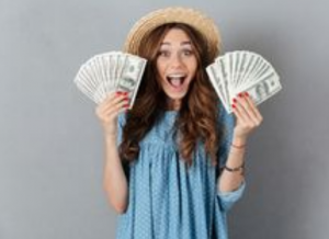 happy woman holding lots of money