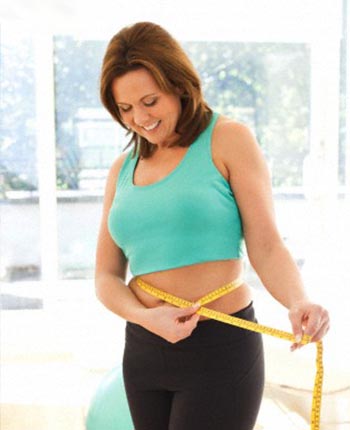 satisfied woman measuring her belly